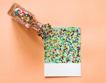 multicolored glitter art on paper