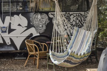 Multicolored Hammock Near Brown Rattan Armchair