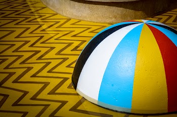 Multicolored Lid on Chevron Flooring