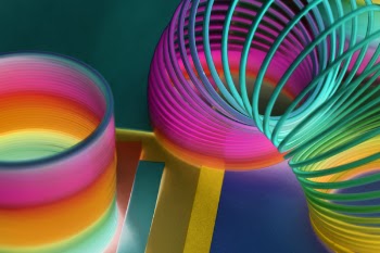 Multicolored Plastic Slinky Toy in Close-up Photography