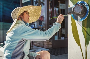 Mural artist Catherine Panofsky, at work in Avila Beach, California. Look her up at: 
http://www.cpdecorativepainting.com