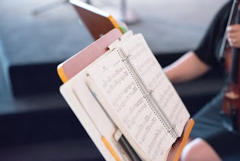Musical Note on Lyrics Stand Shallow Focus Photography