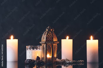 Muslim lamp, glass of milk and tasbih with dates on dark background