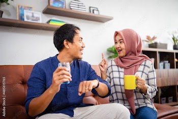 Muslim Malay couple in their home waiting for adzan maghrib