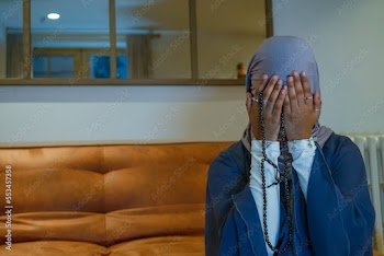 Muslim woman praying at home