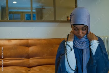 Muslim woman praying at home