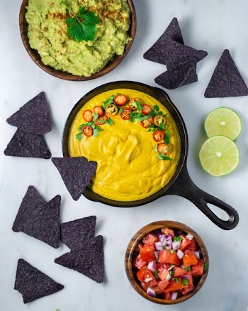 nachos chips with jalapeno and guacamole in bowl