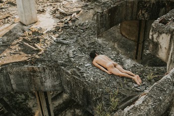Naked Man Lying on Concrete Structure
