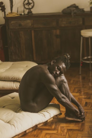 Naked Man Sitting on Mattress