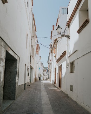 Narrow Pathway Between Concrete Buildings