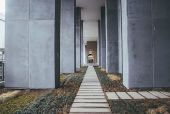 Narrow Pathway Between Concrete Columns