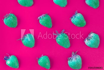 Neon green strawberries on pink patterned background