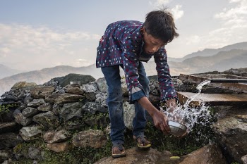 Nepali boy holding water dipper, | Free Photo - rawpixel