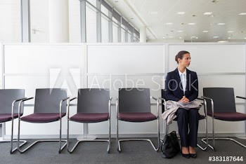 Nervous businesswoman waiting for job interview in office lobby