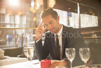 Nervous man preparing to propose in restaurant