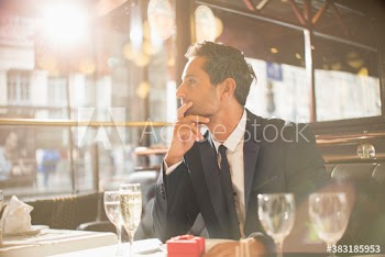 Nervous man waiting to propose in restaurant