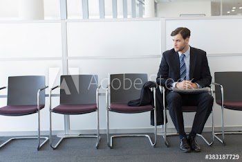 Nervous young businessman waiting in office lobby