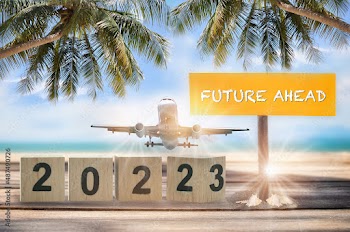 New year 2022 to 2023 and commercial plane with future ahead word on wooden sign on tropical beach background. Happiness holiday travel concept and business transportation recovery after covid-19 idea