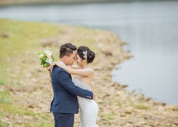 Newly Wed Coupe Standing Near Body of Water