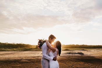 Newly Wed Couple Standing While Facing Each Other and Hugging