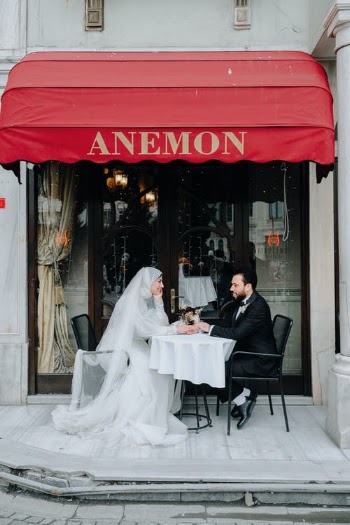 Newlyweds Sitting Together Outside a Cafe Holding Hands on Table · Free Stock Photo