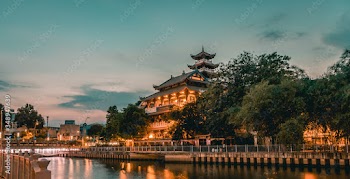 Night scene of Phap Hoa pagoda along Nhieu Loc canal (Saigon river) at night in Ho Chi Minh City, Vietnam
