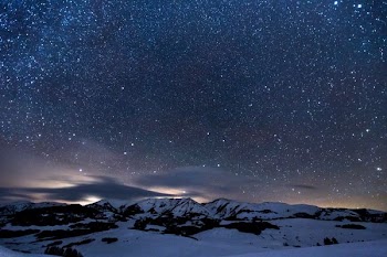 night sky with stars above snow landscape
