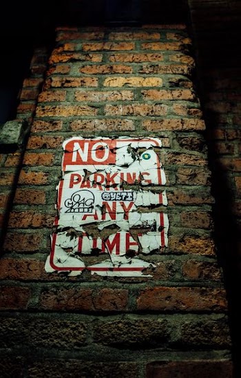 No Parking Any Time sign on wall