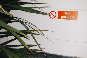 No Parking Sign on White Wall
