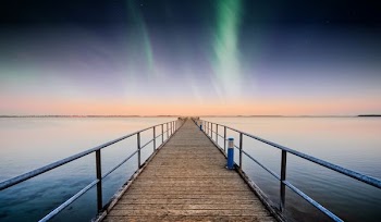 northern lights with sea dock in vicinity