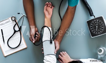 Nurse measuring patient blood pressure