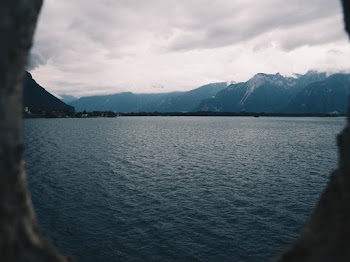 Ocean Near Mountain Under Cloudy Sky
