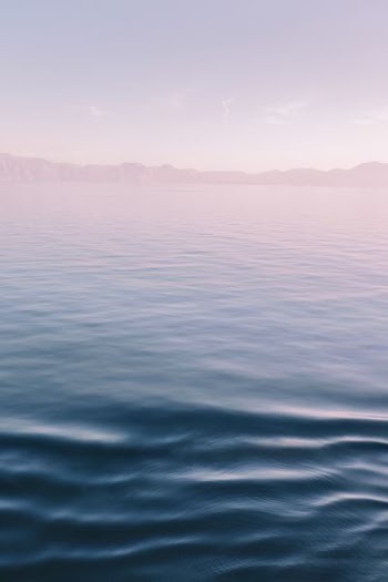 ocean under gray sky during daytime