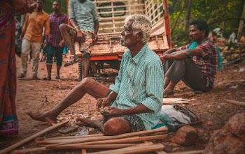 Old Man Sitting on Ground