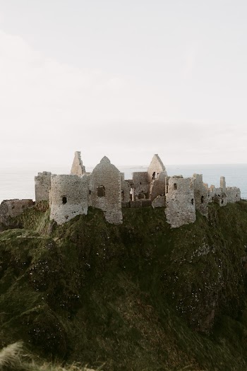 old medieval ruins of Dunluce Castle on ocean coast in northern Ireland famous place in UK