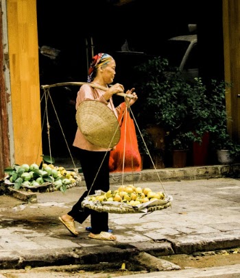 Old Woman Carrying Fruits To Sell