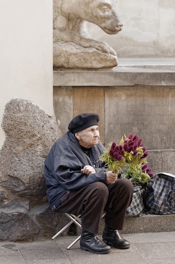 Old Woman Holding Bouquet of Flowers