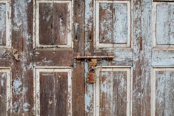 Old Wooden Door With Rusty Padlock