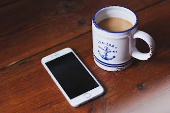 Oldschool mug of latte and an iPhone