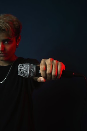 On Stage Performer Holds Out Mic