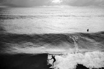 One guy surfing, one not