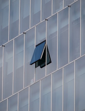 One Open Window on Laminated Glass Building