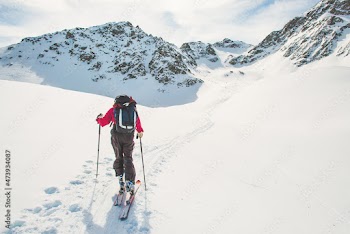 One person follows the track of ascent with ski touring