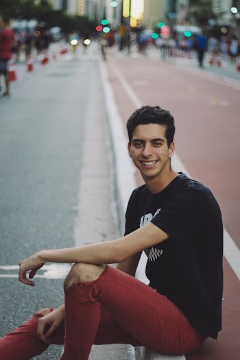 One Unknown Person Smiling Wearing Black Shirt and Red Pants