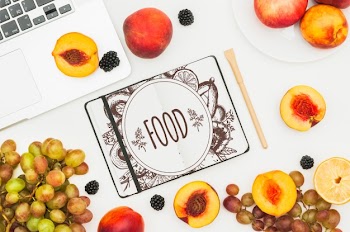 Open book mockup with fruits Free Psd