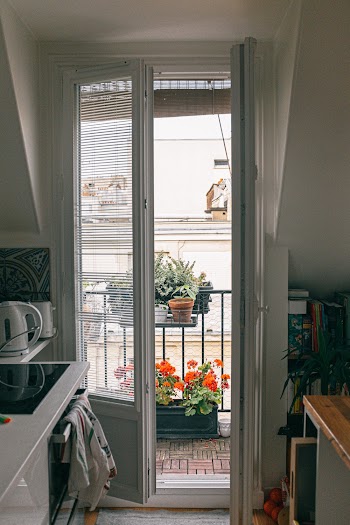 Open Door Showing Orange Petaled Flowers