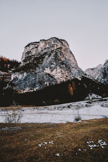 open field near mountain at daytime