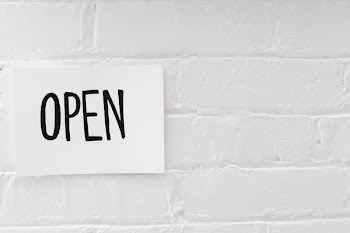 Open Sign On White Brick