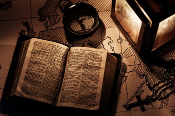 Opened Bible on Wooden Surfaca