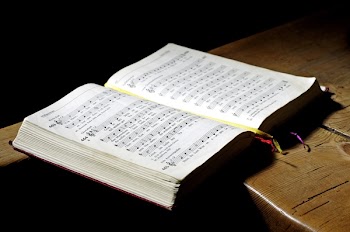 Opened Music Book on Brown Board